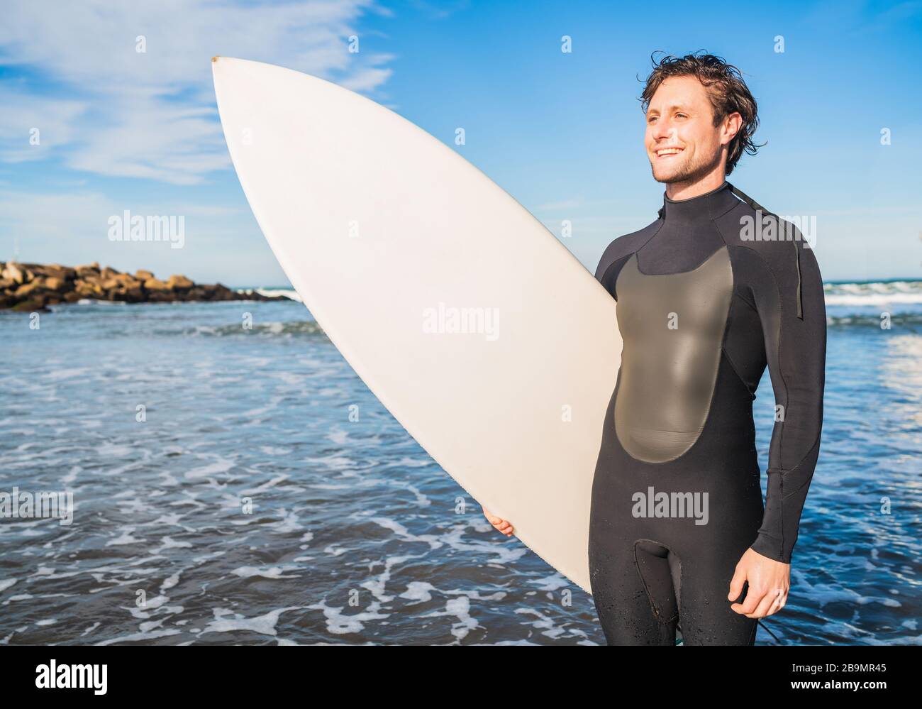 Surfer with black suit hi-res stock photography and images - Alamy
