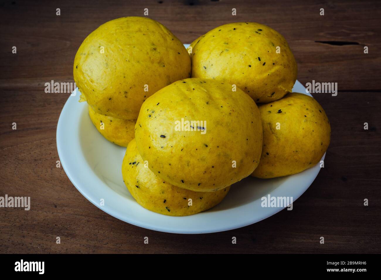 Mantou (traditional Chinese: 饅頭), Chinese/Oriental steamed buns made with pumpkin flesh, ready to eat, homemade. Natural and nice golden yellow colour Stock Photo