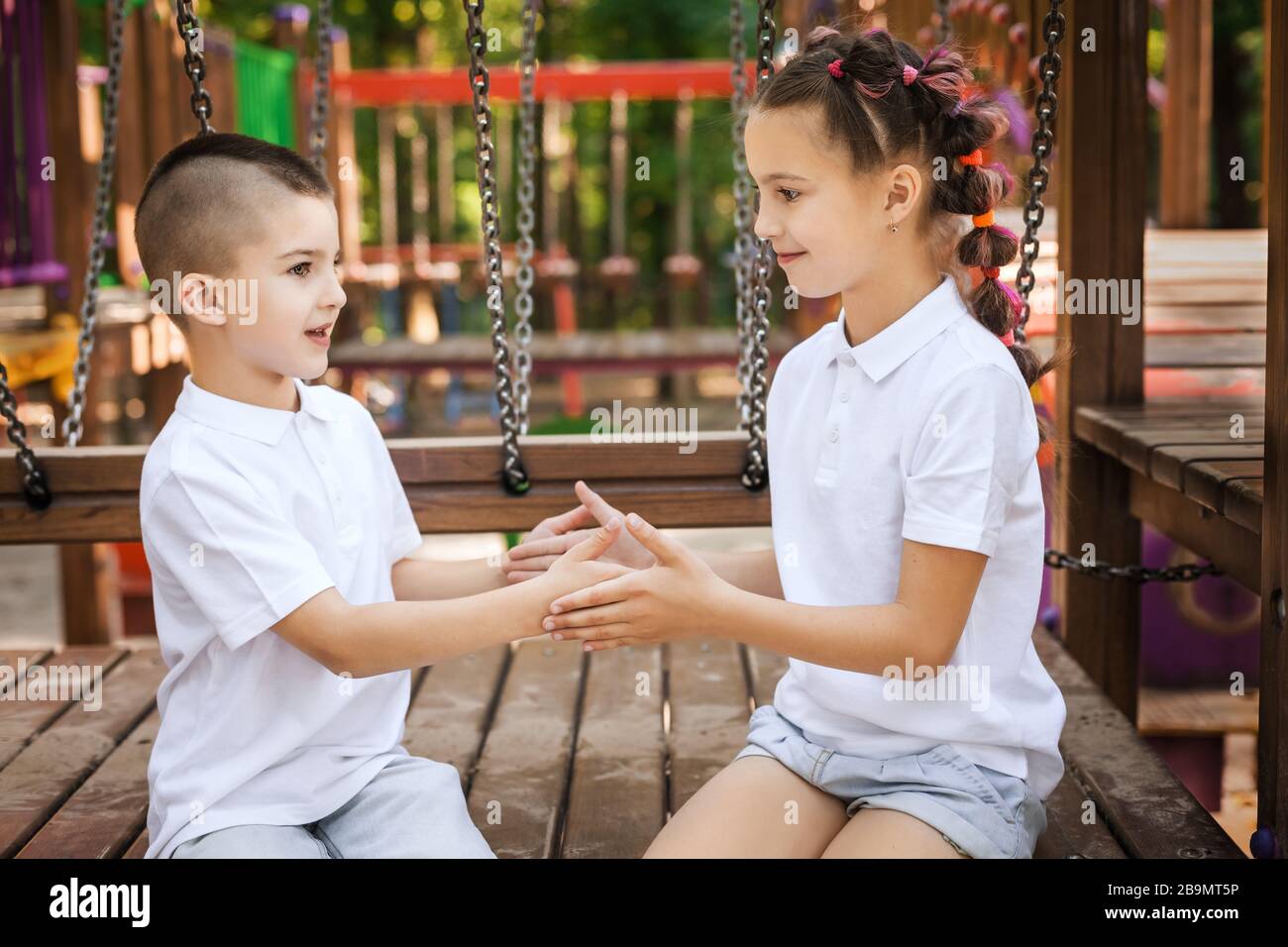 happy boy and girl playing at the playground Stock Photo - Alamy