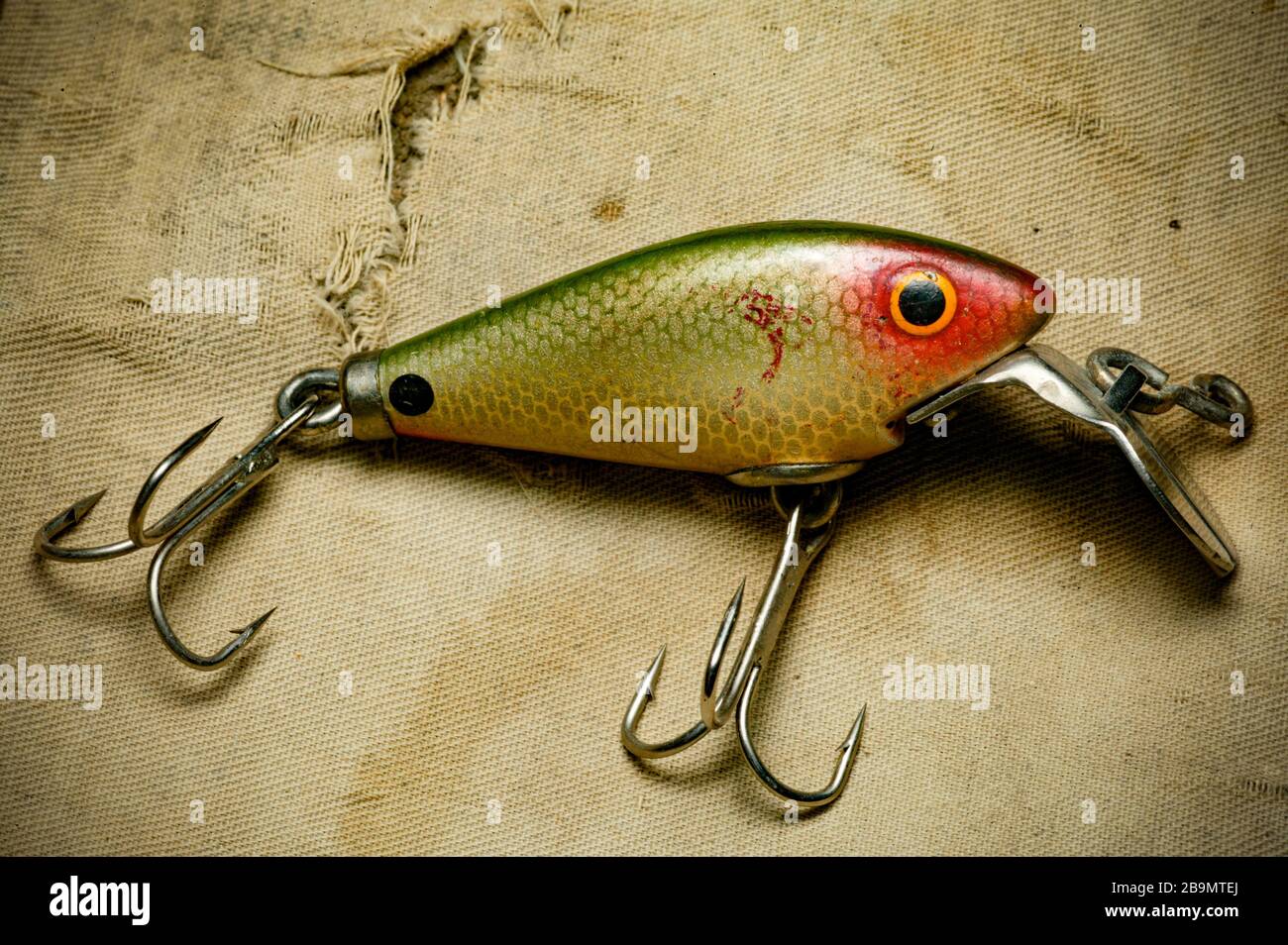 https://c8.alamy.com/comp/2B9MTEJ/an-example-of-a-vintage-fishing-lure-equipped-with-treble-hooks-possibly-made-by-woods-mfg-displayed-on-an-old-fishing-bag-lures-such-as-these-are-2B9MTEJ.jpg