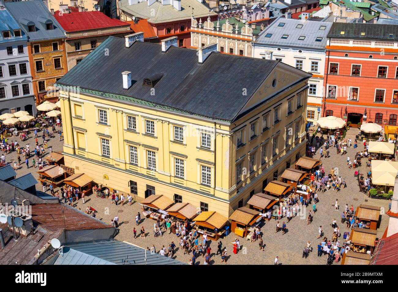 Lublin, Lubelskie / Poland - 2019/08/18: Panoramic view of old town quarter with market square and historic XVI century High Royal Court building - Tr Stock Photo