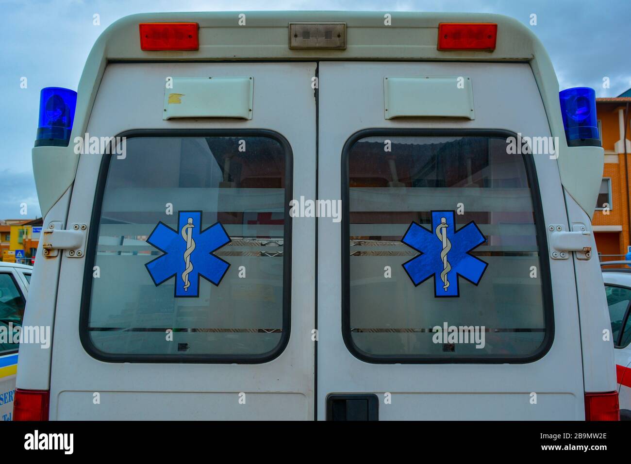 Back of an italian ambulance car. Closeup of the backdoor of an ambo vehicle carring paramedics for emergency situations and patients in need. Symbol Stock Photo