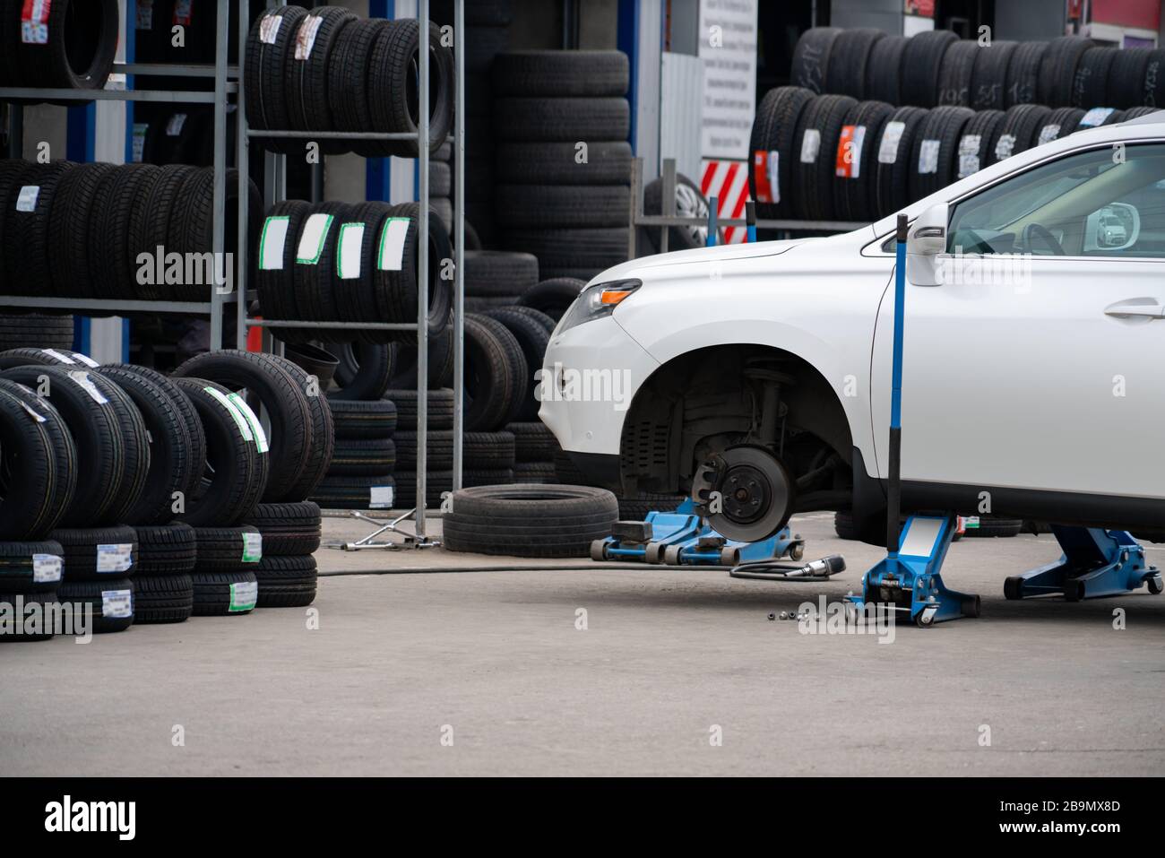 Seasonal tire change at a tire shop service Stock Photo