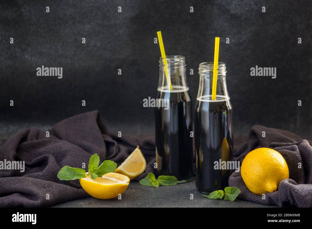 Bottles with detox activated charcoal black lemonade on table. Healthy  lifestyle drink. Natural hangover cure Stock Photo - Alamy
