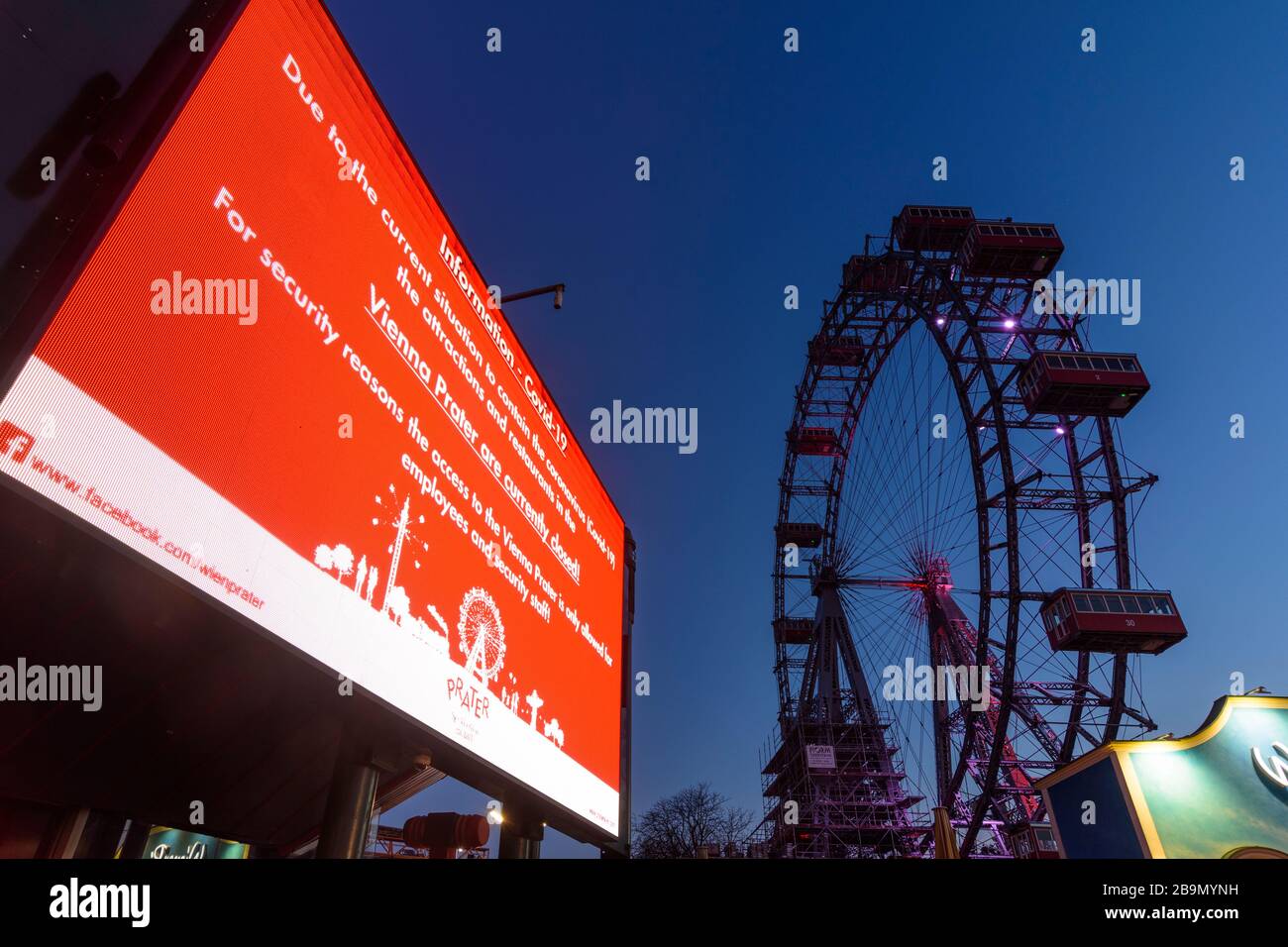 Wien, Vienna: information video wall with text that Prater is closed (in English), Ferris Wheel at Prater closed due to corona virus (COVID-19), in 02 Stock Photo