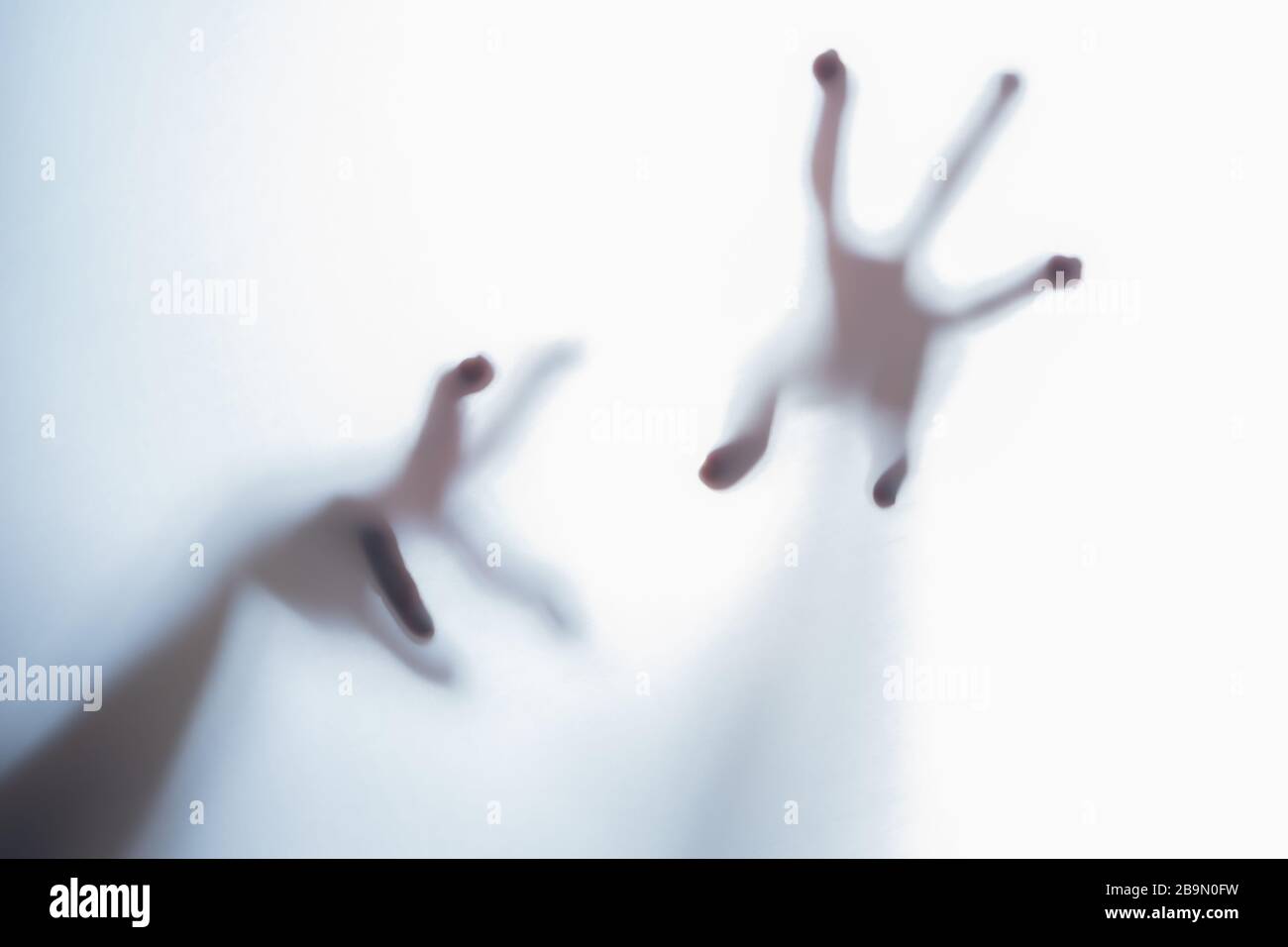 Shadow of blurred creepy fingers from an unknown creature like an alien. Stock Photo