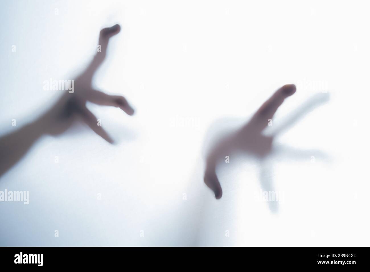 Shadow of blurred creepy fingers from an unknown creature like an alien. Stock Photo