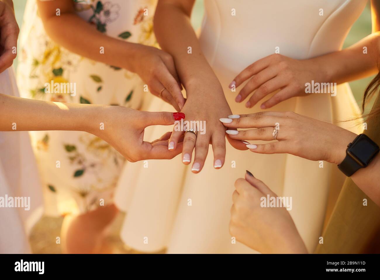 The Girl On Hen-party Shows An Engagement Ring. Close-up. Pre-wedding Care Concept. Beautiful Shiny Smile. Resting With Bride. Sunny Day. Good Mood. Y Stock Photo