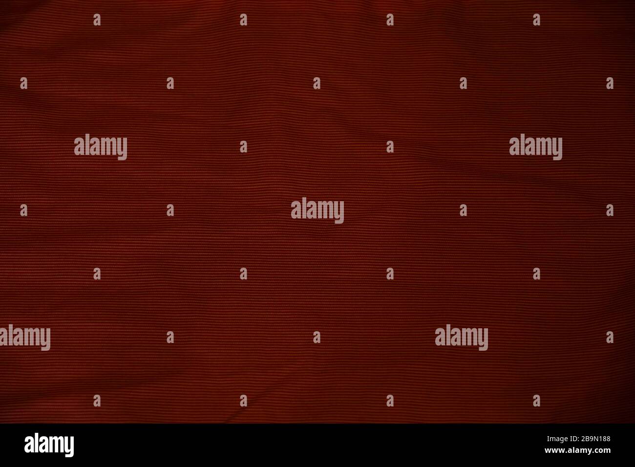 Crumpled burgundy fabric texture background Stock Photo