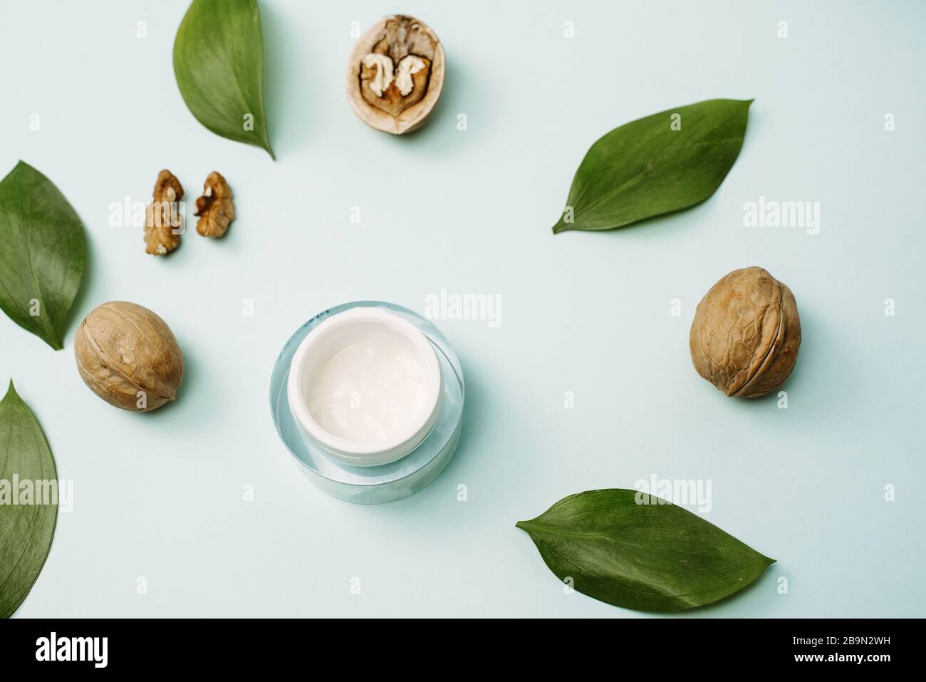 Yellow cream made from natural ingredients on a blue pastel background