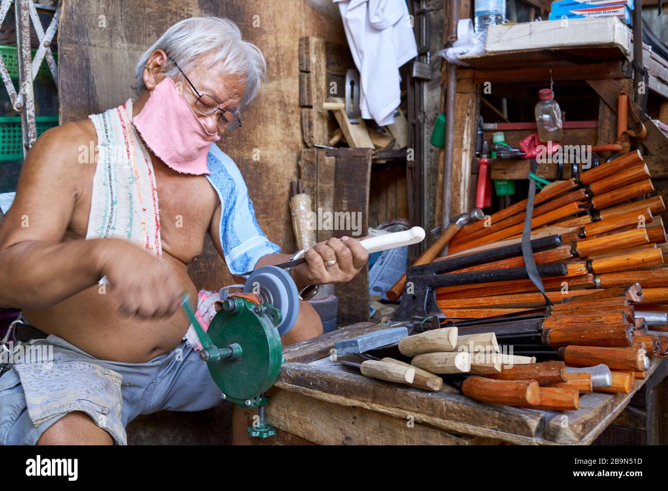 Man sharpening knives. Stock Photo