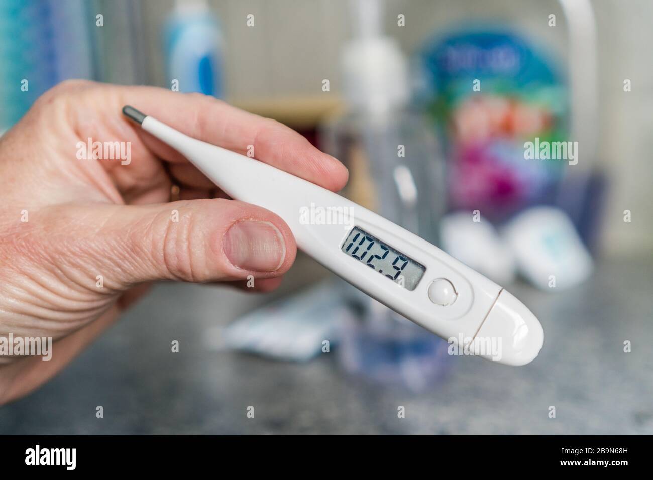 https://c8.alamy.com/comp/2B9N68H/close-up-of-hand-holding-thermometer-measuring-a-high-fever-2B9N68H.jpg