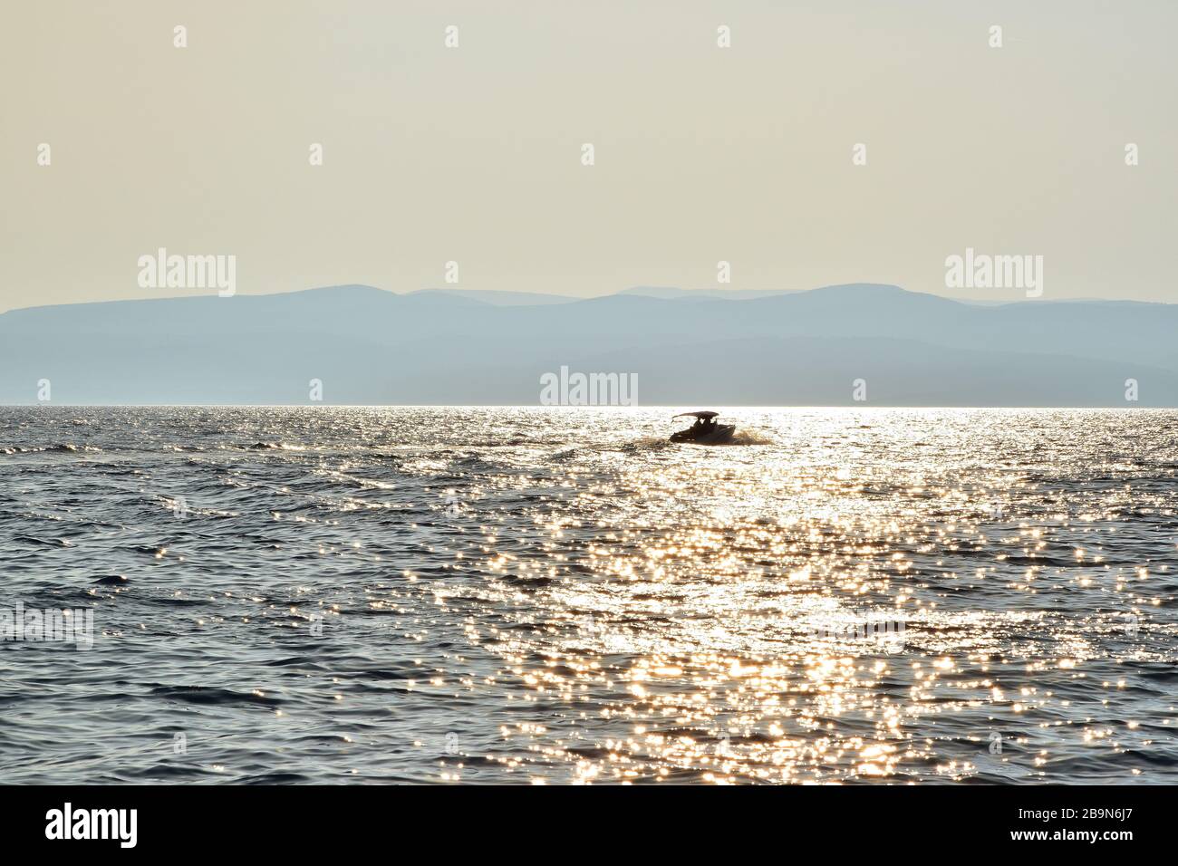 Amazing golden sunset reflection on the water at the sea with boat ...