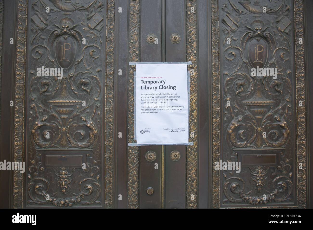 Closed sign on the doors for the New York Public Library 42nd Street entrance due to the Corona outbreak. New York City. Stock Photo