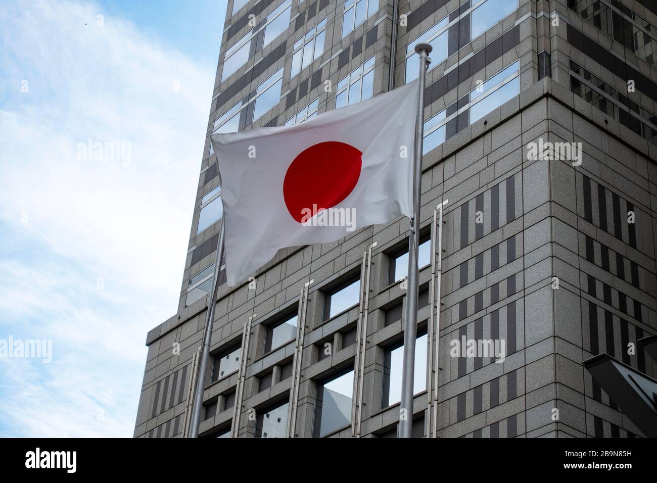 Tokyo, Japan - May 22, 2019 - Flag of Japan outside Tokyo Metropolitan Government Building. Located in Shinjuku, the building was designed by architec Stock Photo
