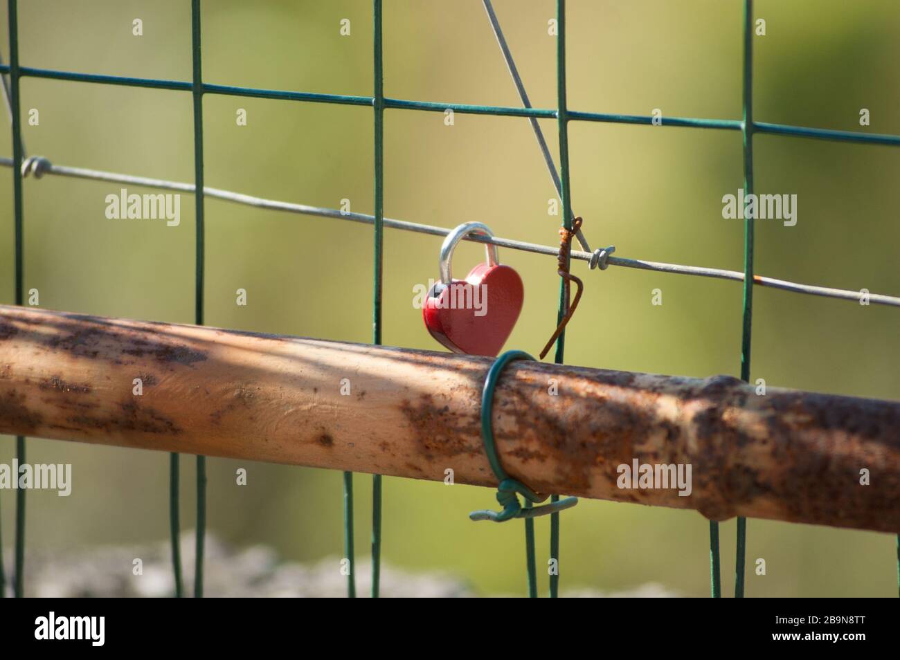red heart-shaped padlock hanging on a railing Stock Photo - Alamy