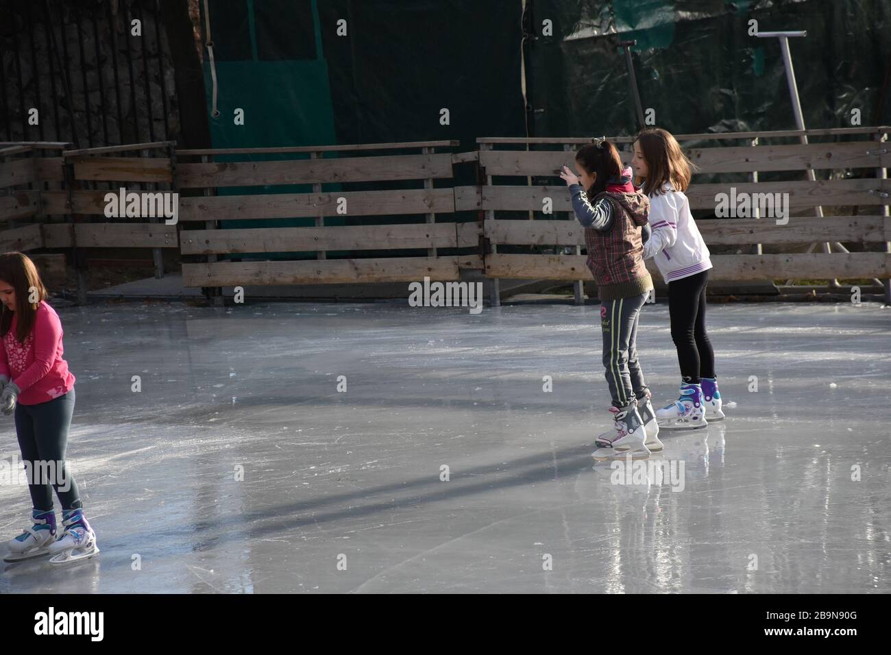 An ice skating rink was made in one Belgrade sports center. Three girls