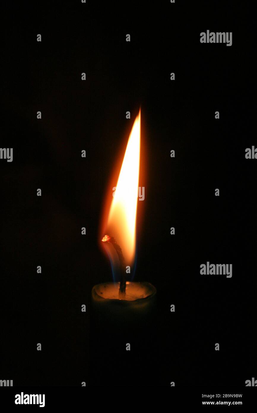 Flame of a candle burning in the dark Stock Photo Alamy
