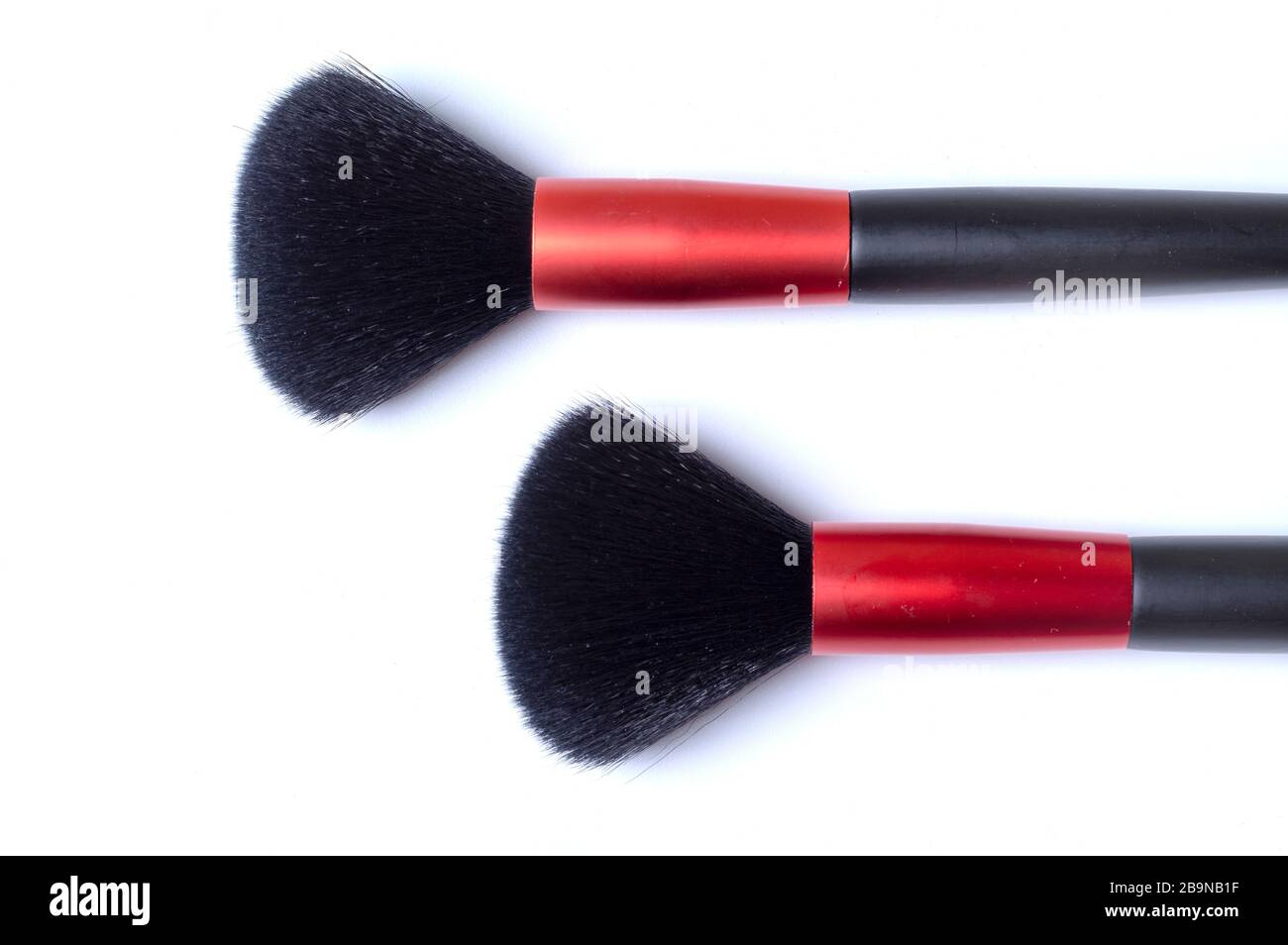 two makeup brushes on a white background, top view. Close-up photo. Stock Photo