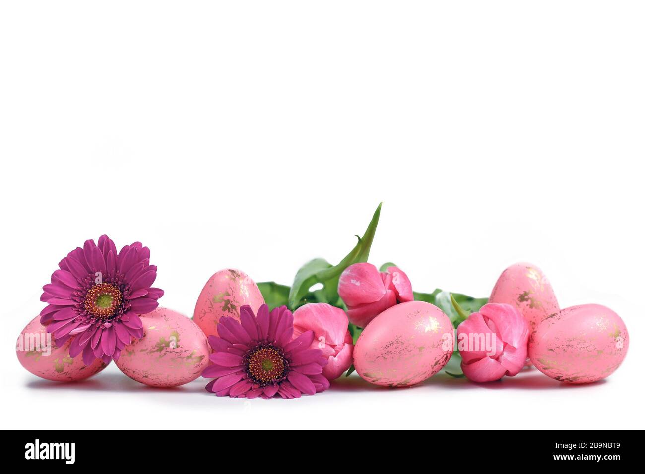 Pink easter eggs with golden pattern and spring flowers on white ...