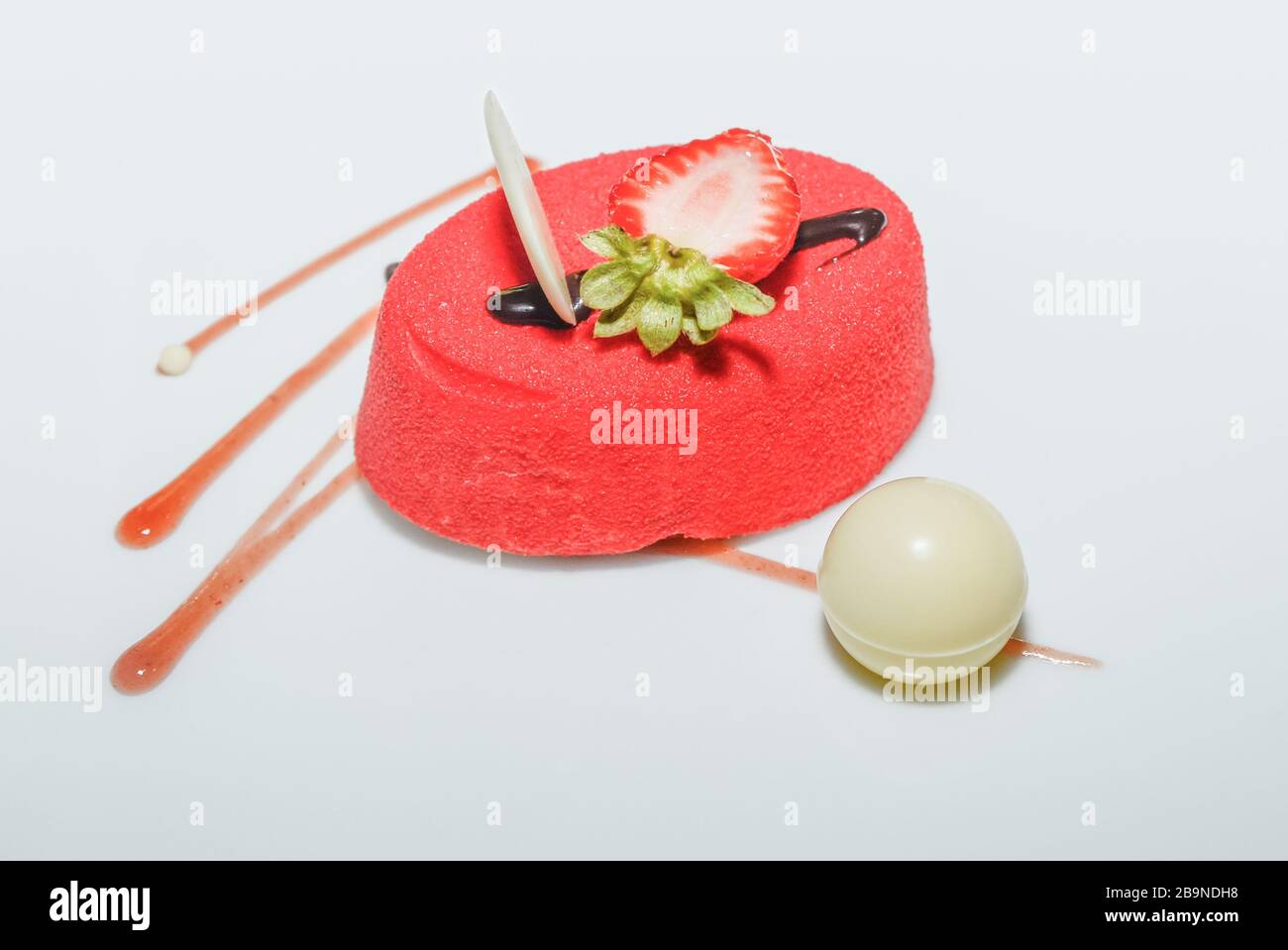 Strawberry cake with sugar coating and chocolate ball Stock Photo