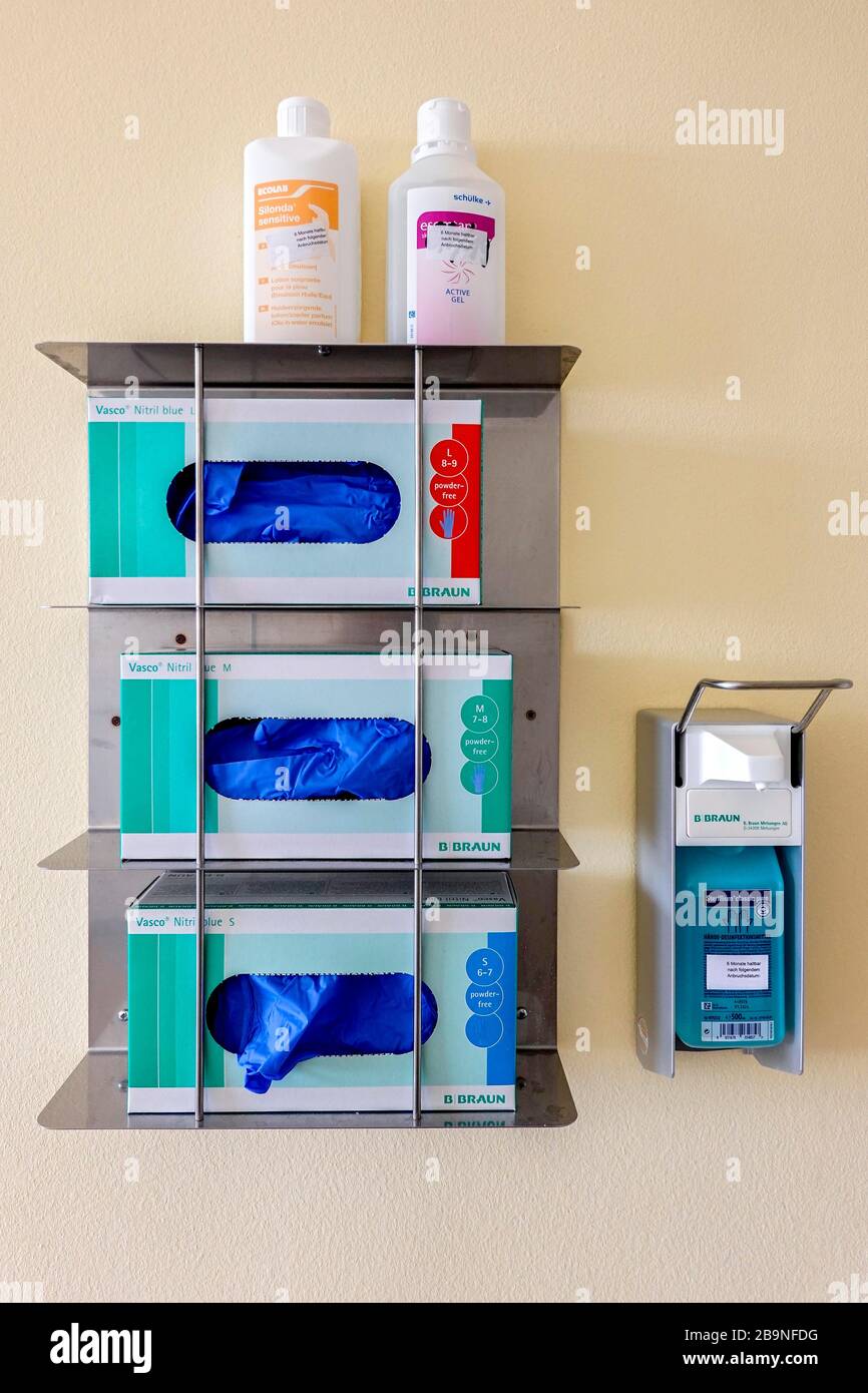 Dispenser with disposable gloves and disinfectant in hospital, Bavaria, Germany Stock Photo