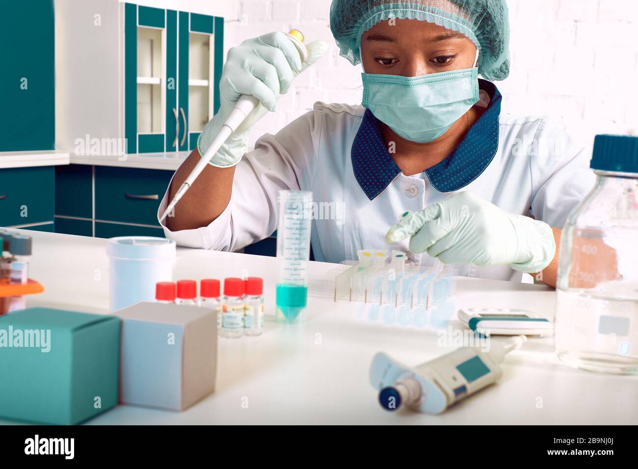 Female African medical students, young graduates in research laboratory or medical test lab perform various testing on patient samples. nucleic acids Stock Photo