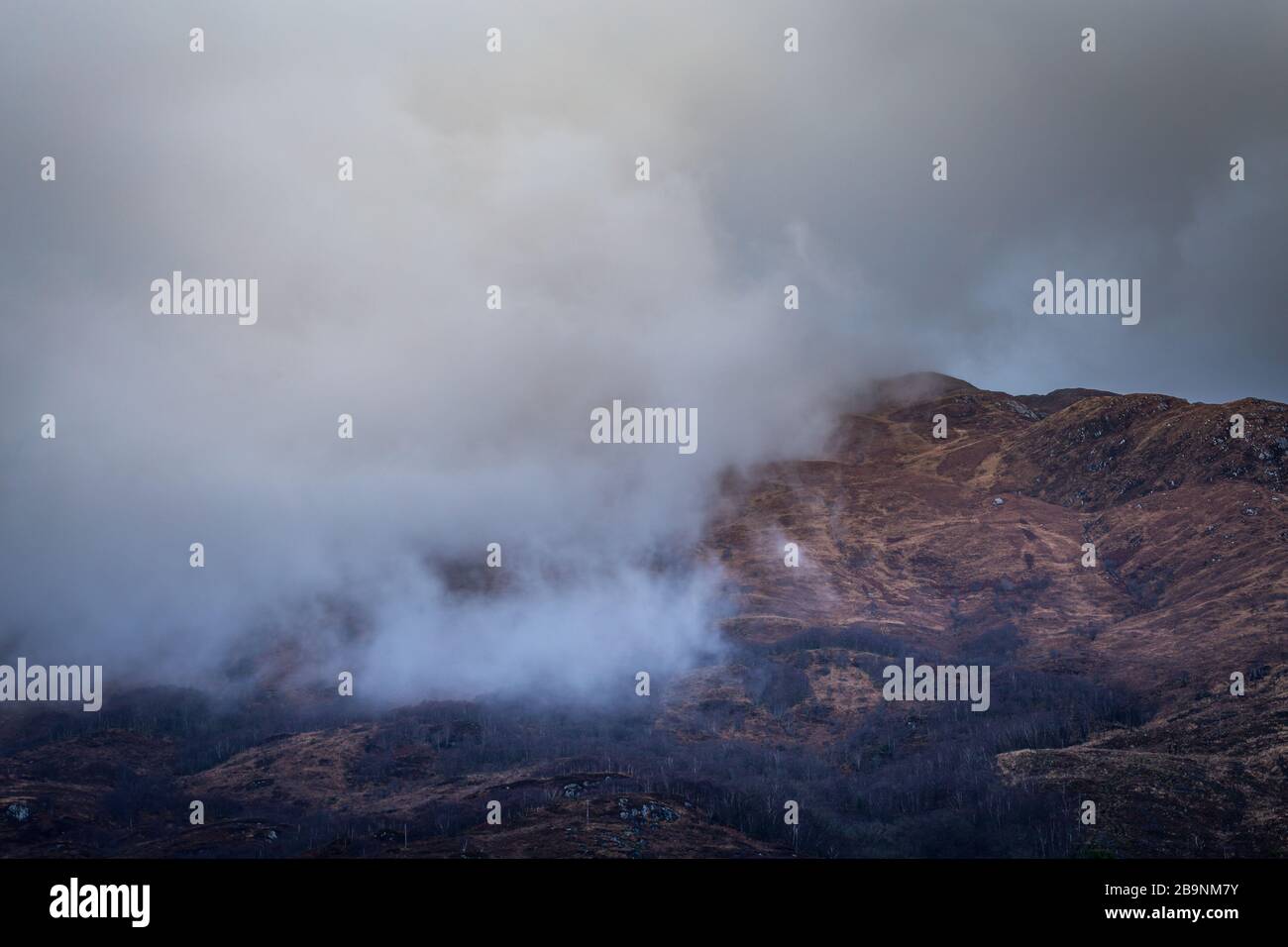 Cloud capped scenic mountain range at rainy day in Scottish Highlands, UK Stock Photo