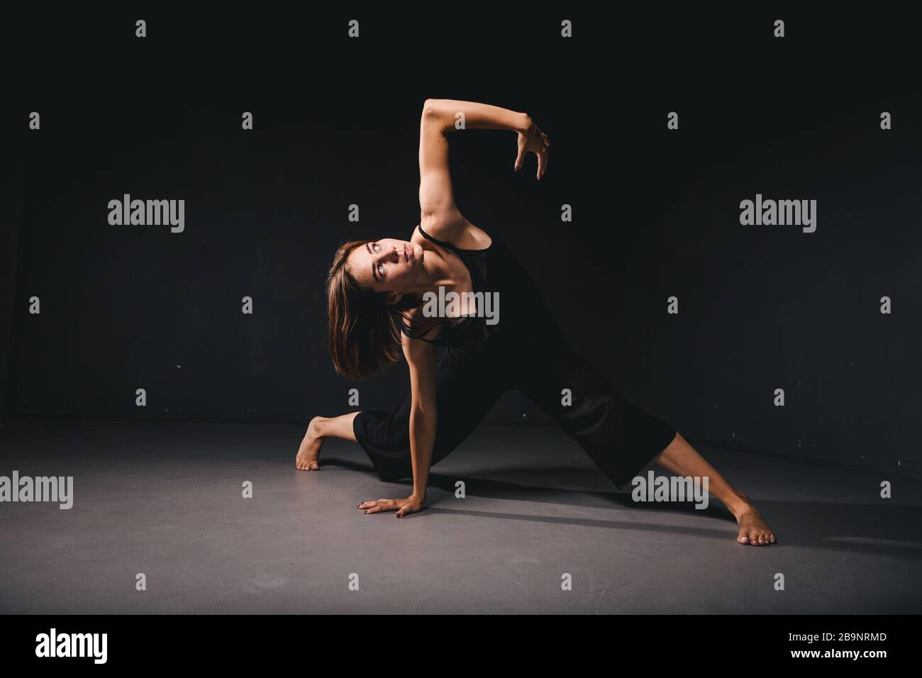 Portrait of a beautiful woman dancing on black background. Ballet and  contemporary dancer dancing on dark backdrop. Contemporary Art. Plastic and  Stock Photo - Alamy
