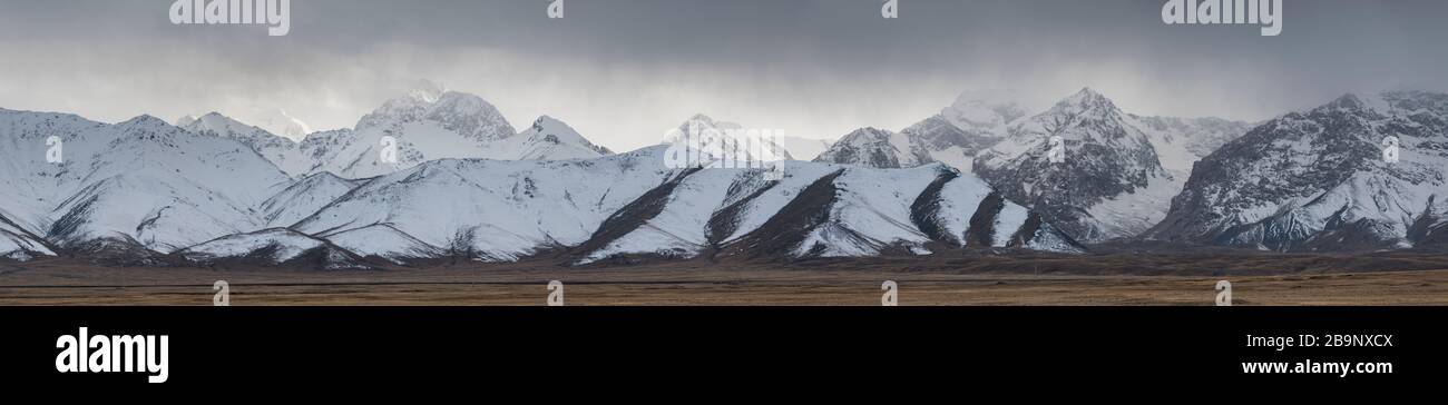 mountain landscape showing the typical Tian Shan mountains around Chatyr Kol lake in Kyrgyzstan Stock Photo