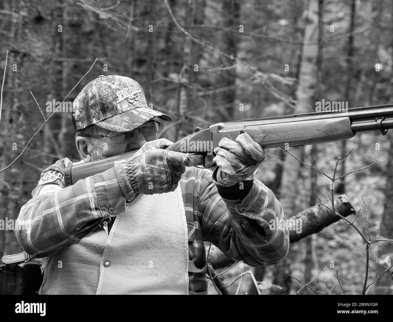 Old man hunting with a 12 gauge shotgun in Canada Stock Photo