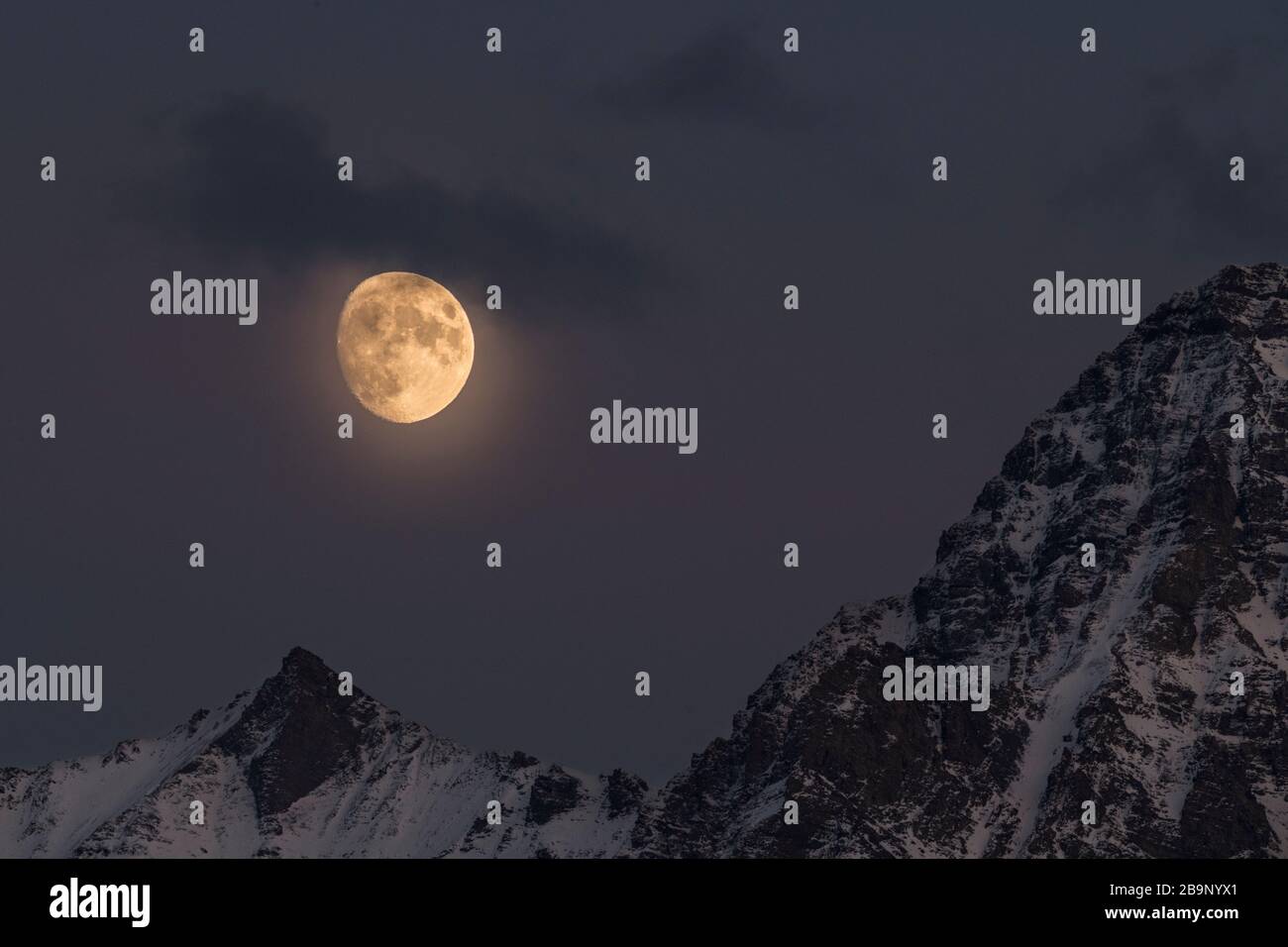Last night before the supermoon rising over the Tian Shan mountains in southern Kyrgyzstan Stock Photo