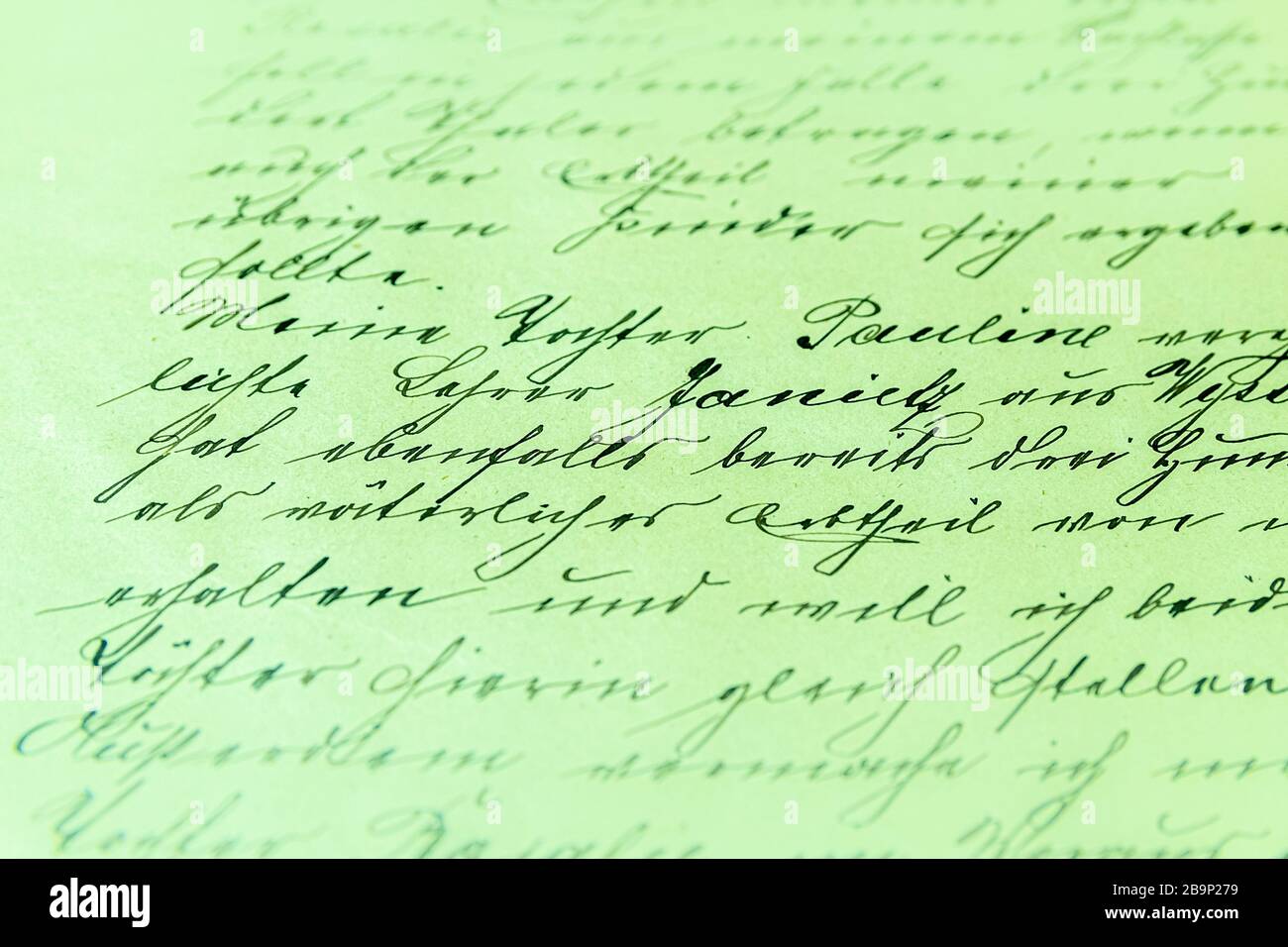Closeup of a text written with fancy handwriting in a diary under the ...