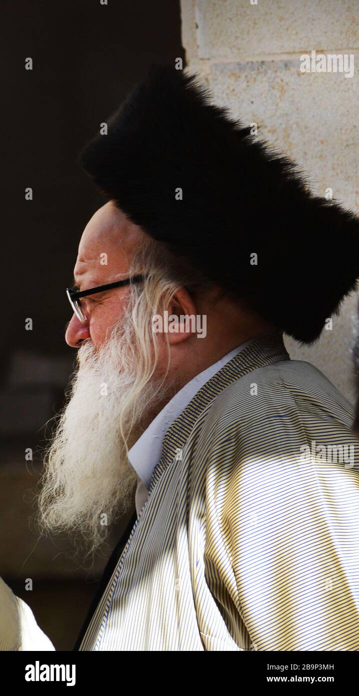 A Hasidic Jewish man wearing a Shtreimel ( traditional Fur hat ) in Mea Shearim neighborhood in Jerusalem. Stock Photo
