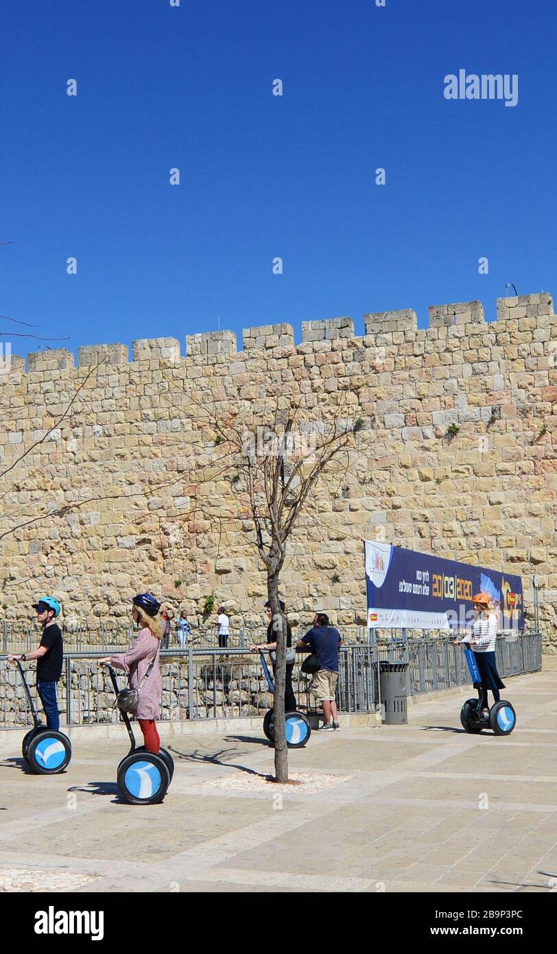 Tourist riding two wheel electric scooters near Jaffa gate in Jerusalem