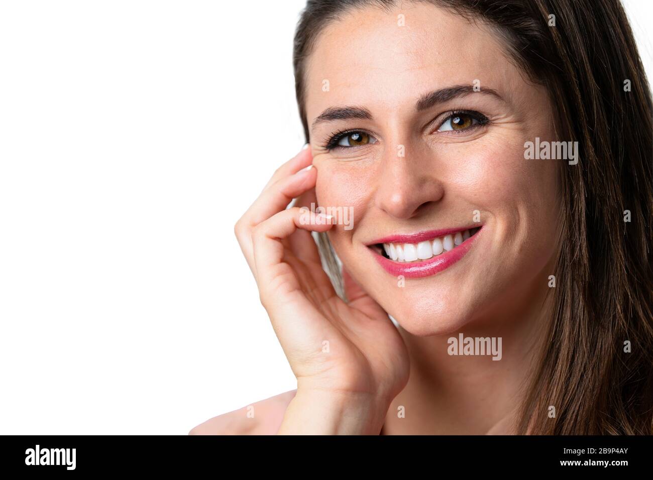 Beautiful female model with natural make-up and lipstick, white teeth, smiling with perfect skin complexion Stock Photo