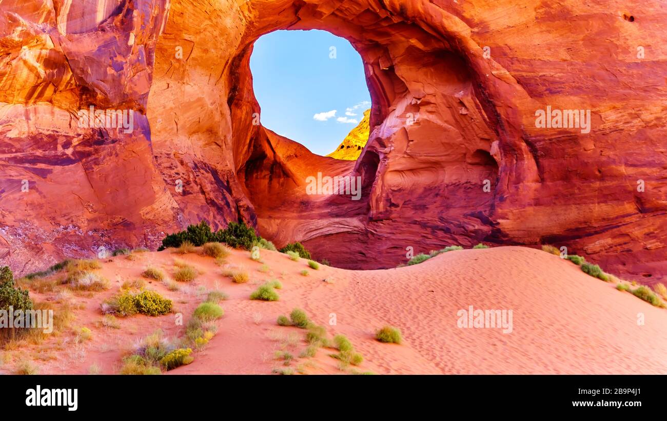 The Ear of The Wind, a hole in a rock formation in Monument Valley Navajo Tribal Park on the border of Utah and Arizona, United States Stock Photo