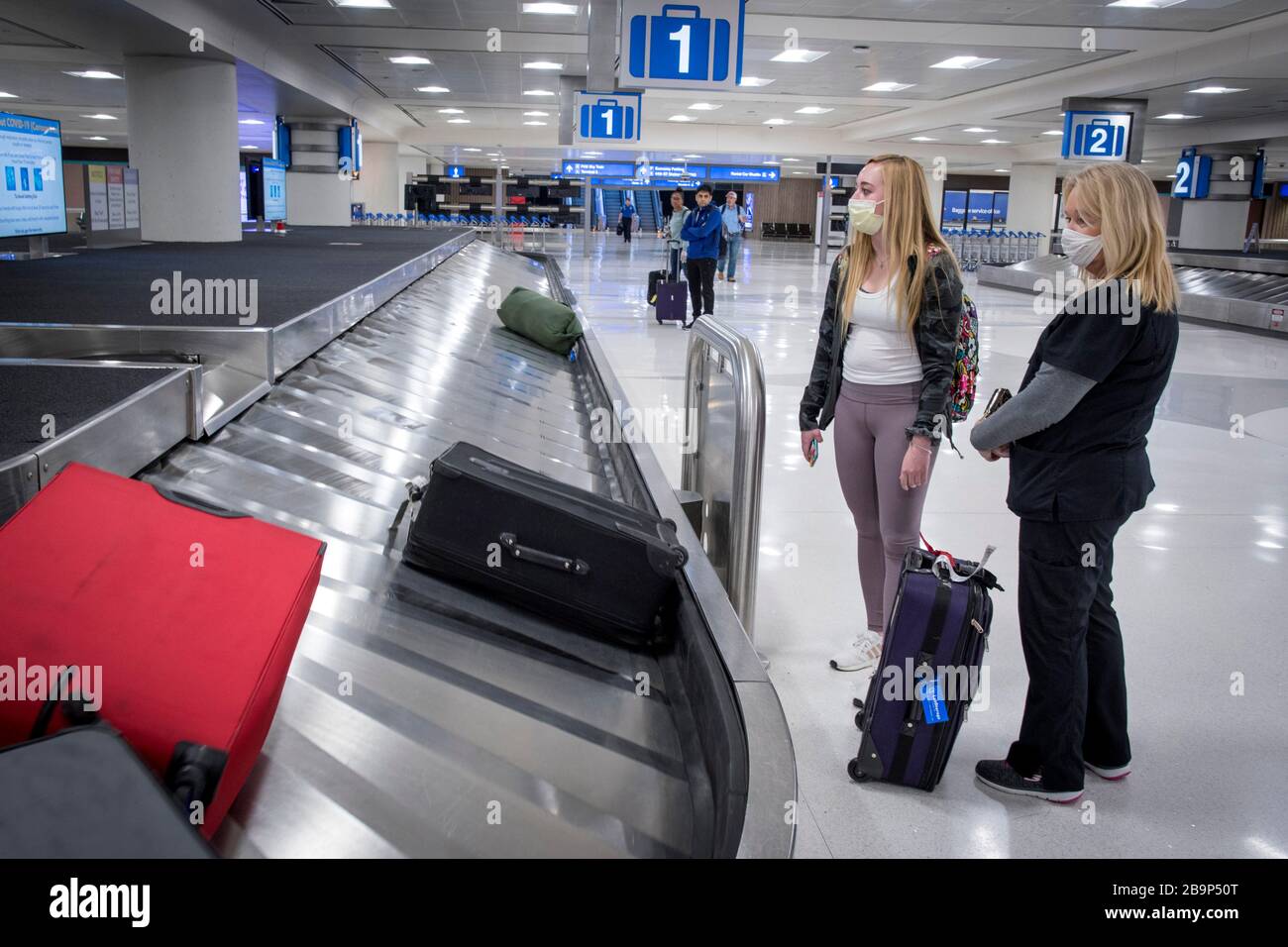 Phoenix, Arizona, USA. 24th Mar, 2020. Kathy Argenta, right, meets her  daughter Kaitlin Leonard at a sparsely populated Sky Harbor International  Airport in Phoenix, Arizona, March 24, 2020. Leonard was returning home