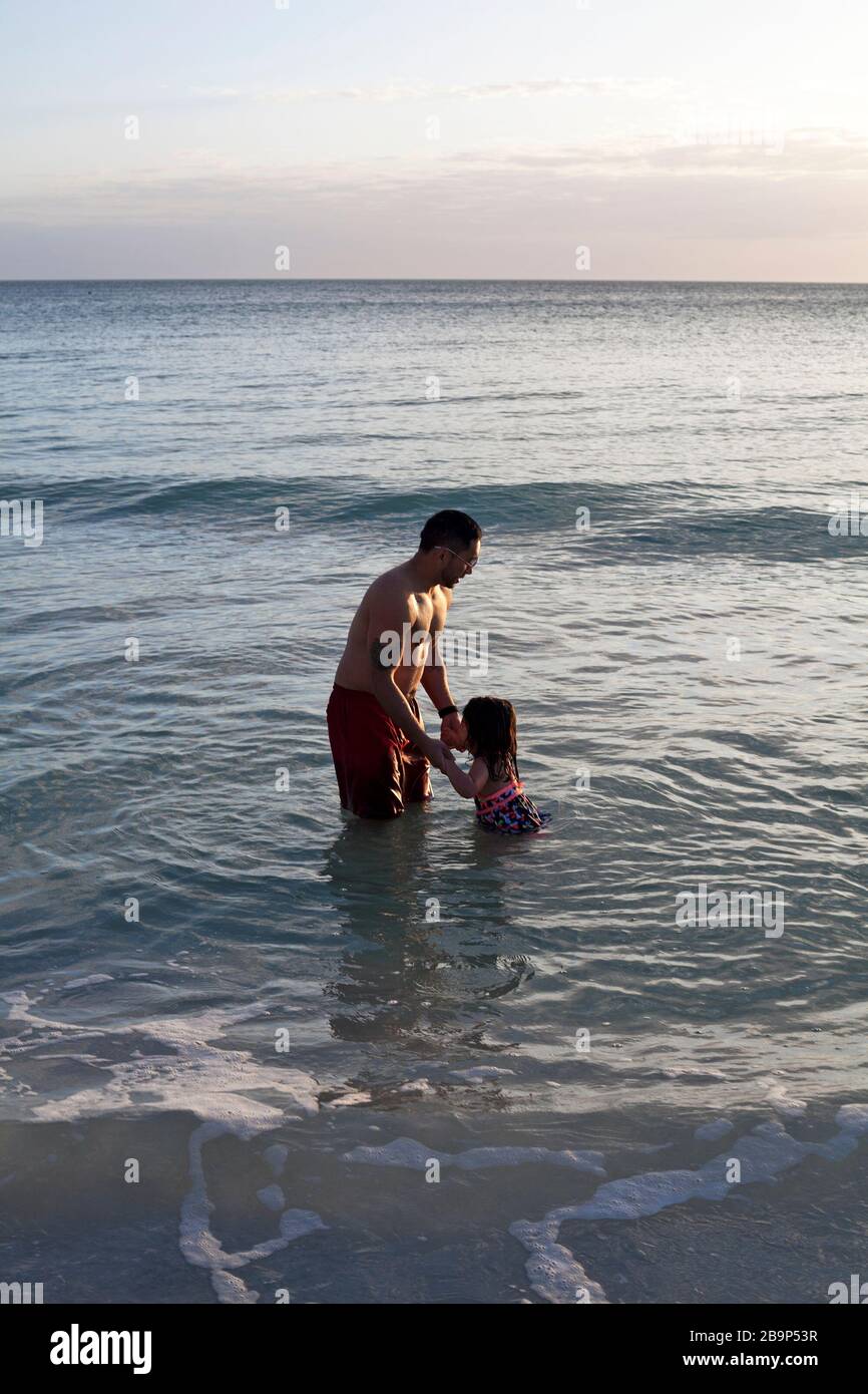 A father and daughter play in the ocean on Anna Maria Island in Florida, USA. Stock Photo