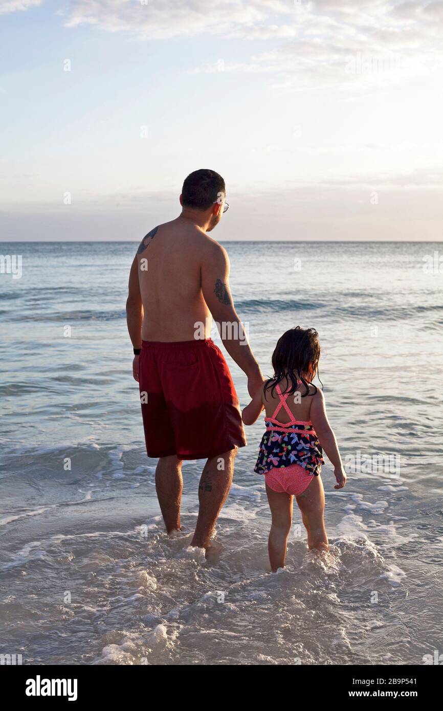 A father and daughter play in the ocean on Anna Maria Island in Florida, USA. Stock Photo