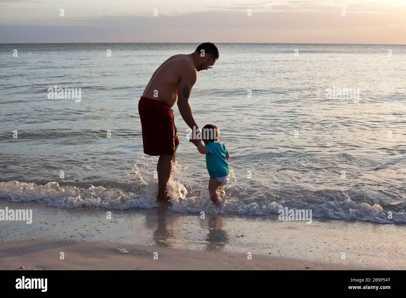 A father and son play in the ocean on Anna Maria Island in Florida, USA. Stock Photo