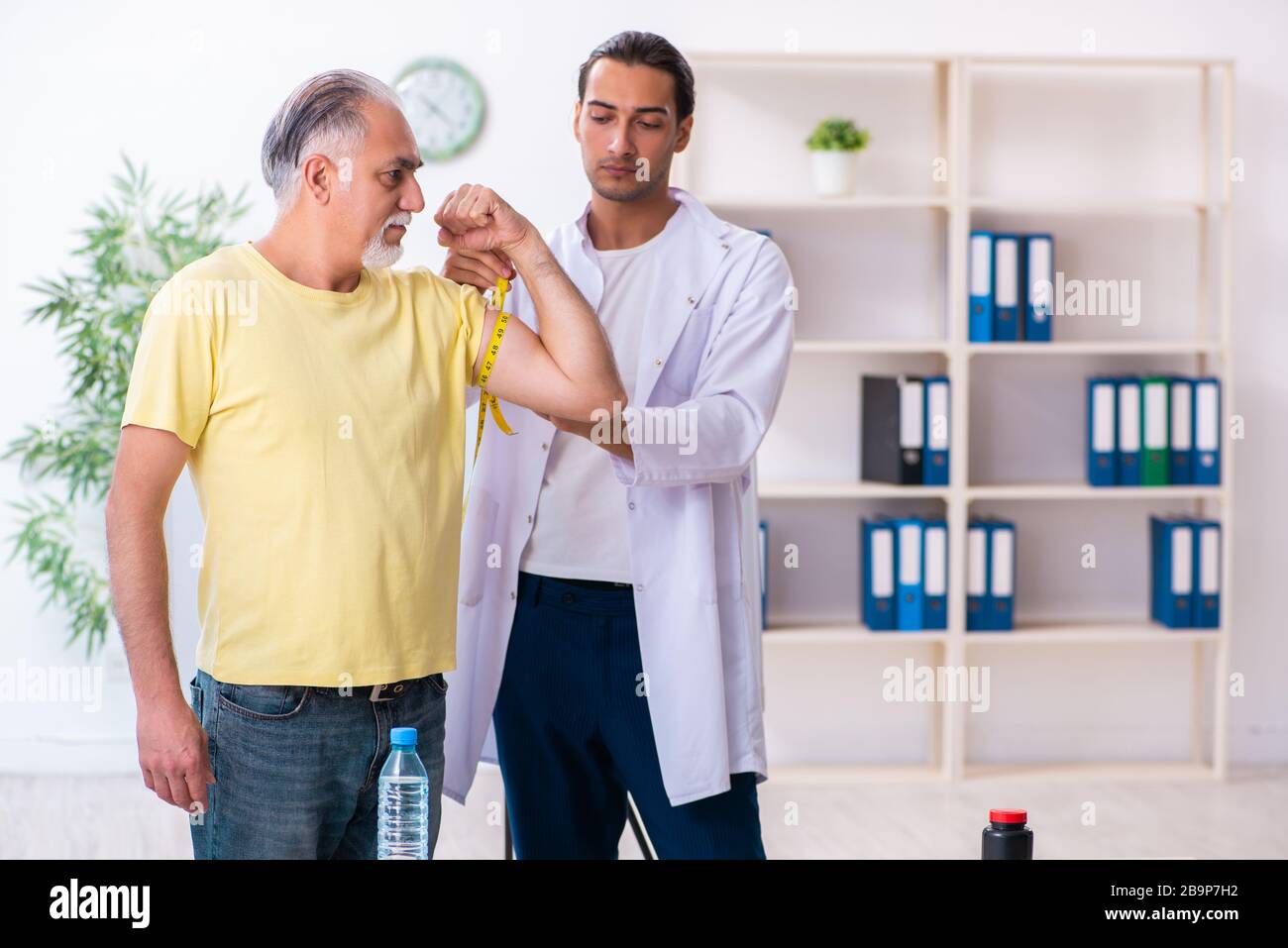 The doctor dietician giving advices to fat overweight patient Stock