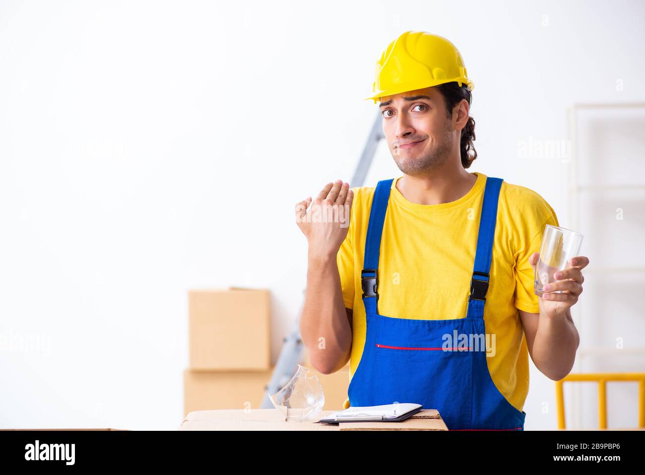 Young professional mover doing home relocation Stock Photo