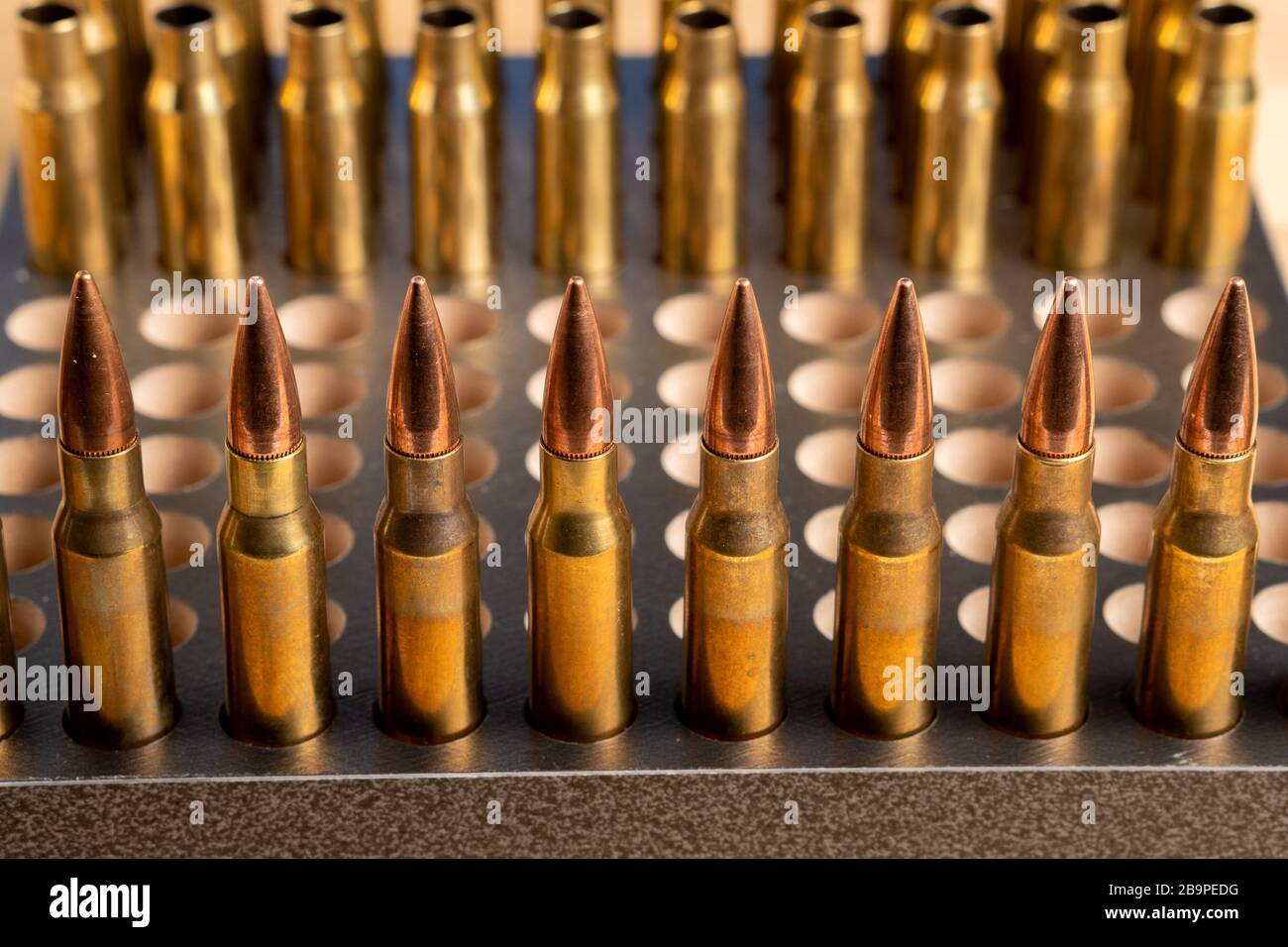 Production of cartridges for a rifle, reload. Empty shells and ammunition. Close up Stock Photo