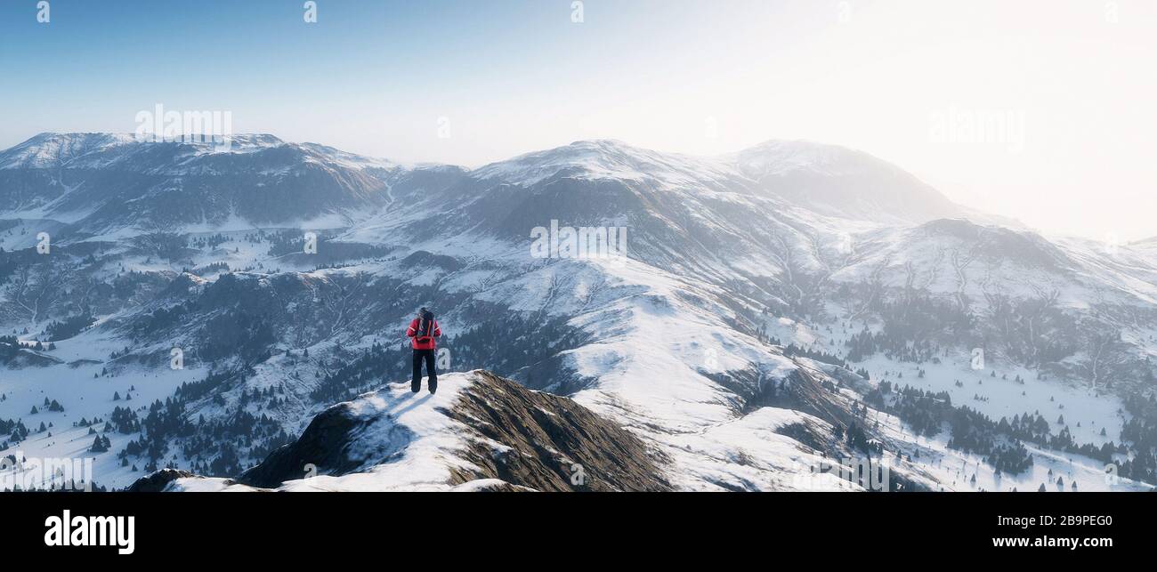 Traveler with a backpack on top of snow mountains . This is a 3d render illustration . Stock Photo