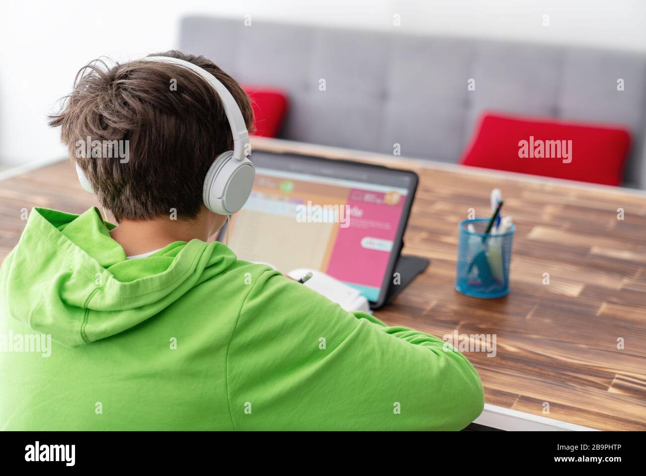 Young boy is studying in front of the laptop. E learning, study at home online Stock Photo