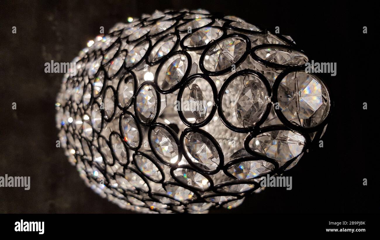 Sparkling scale with crystal round elements inside. Shiny surface of glass chandelier. Modern glass lampshade texture looks like disco ball. Stock Photo