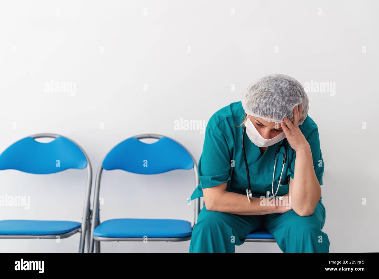 Woman doctor is sitting and has, worry, frustration, tiredness and exhausting deep feelings Stock Photo