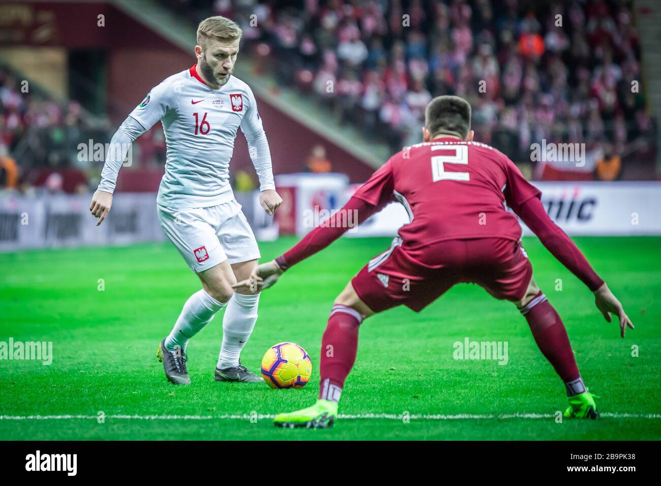 Jakub Blaszczykowski (L) of Poland and Vitalijs Maksimenko (R) of Latvia are seen in action during the UEFA EURO 2020 Qualifiers (Group D) match between Poland and Latvia at PGE Narodowy Stadium.(Final score; Poland 2:0 Latvia) Stock Photo