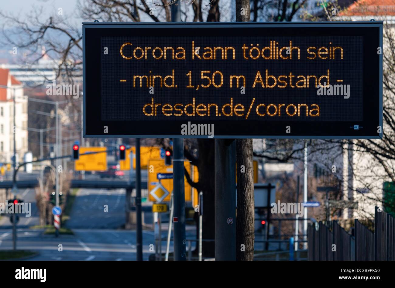 25 March 2020, Saxony, Dresden: On a digital scoreboard in Dresden's university quarter it says "Corona can be deadly - at least 1.50 metres away". To contain the corona virus, Saxony now bans all accumulations of three or more people in public places. Photo: Robert Michael/dpa-Zentralbild/dpa Stock Photo